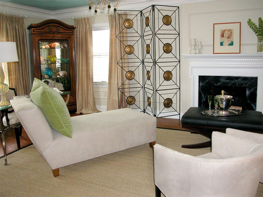 A beautiful sofa with cream coat and green pillow